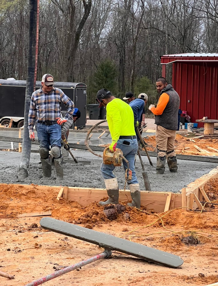 A group of custom house builders working on a home construction site in Shreveport