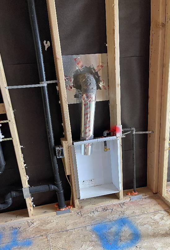 Residential HVAC system installation with pipes and ducts within a wooden frame by highly trained & certified technicians.