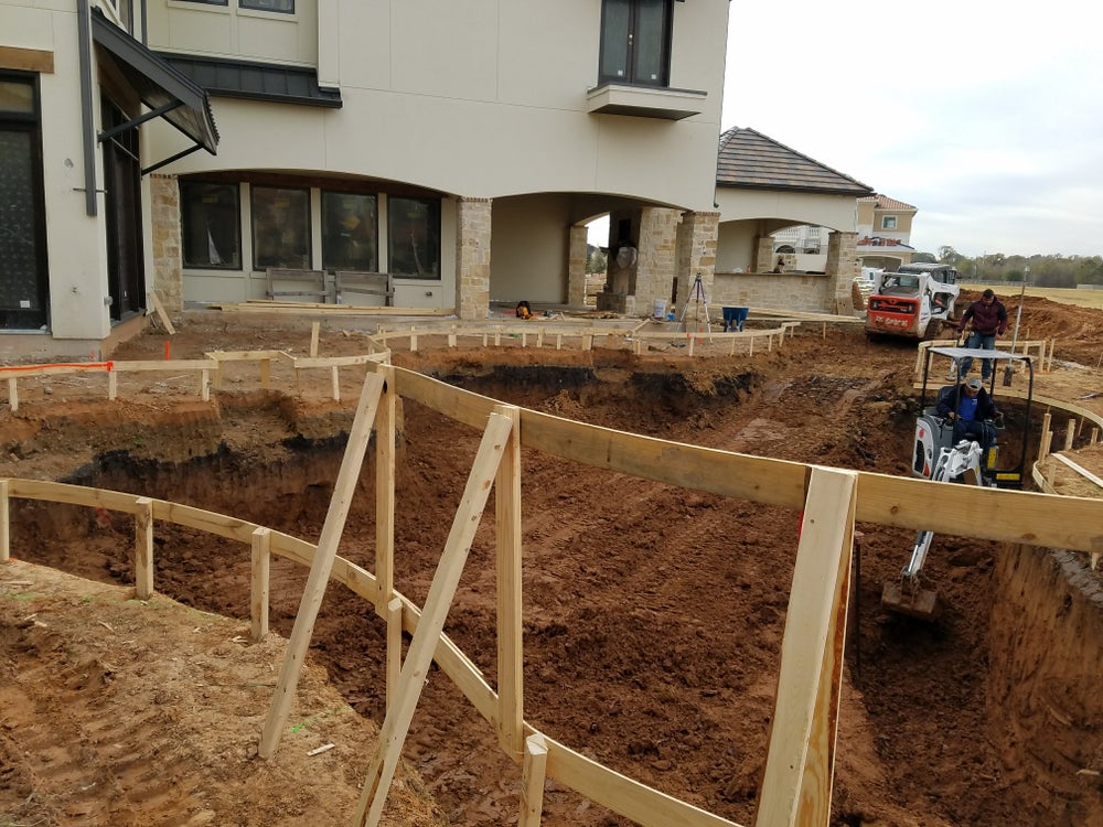 A group of workers doing pool construction
