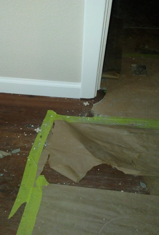 Damaged concrete foundation near doorway needing repair