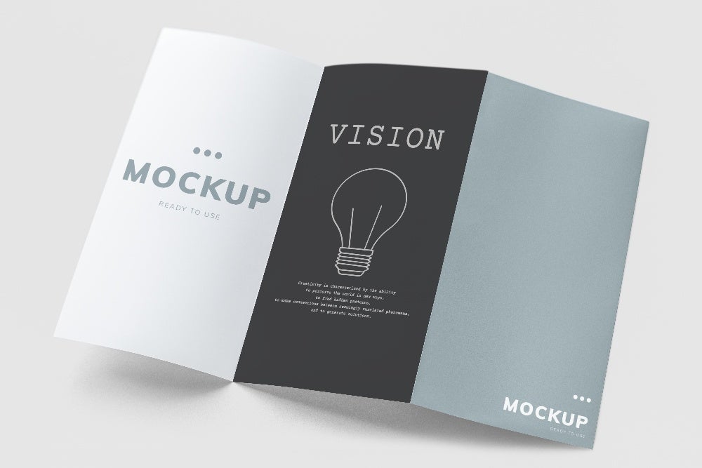 Trifold brochure mockup featuring minimalist design with sections labeled 'Mockup' and 'Vision' with lightbulb illustration