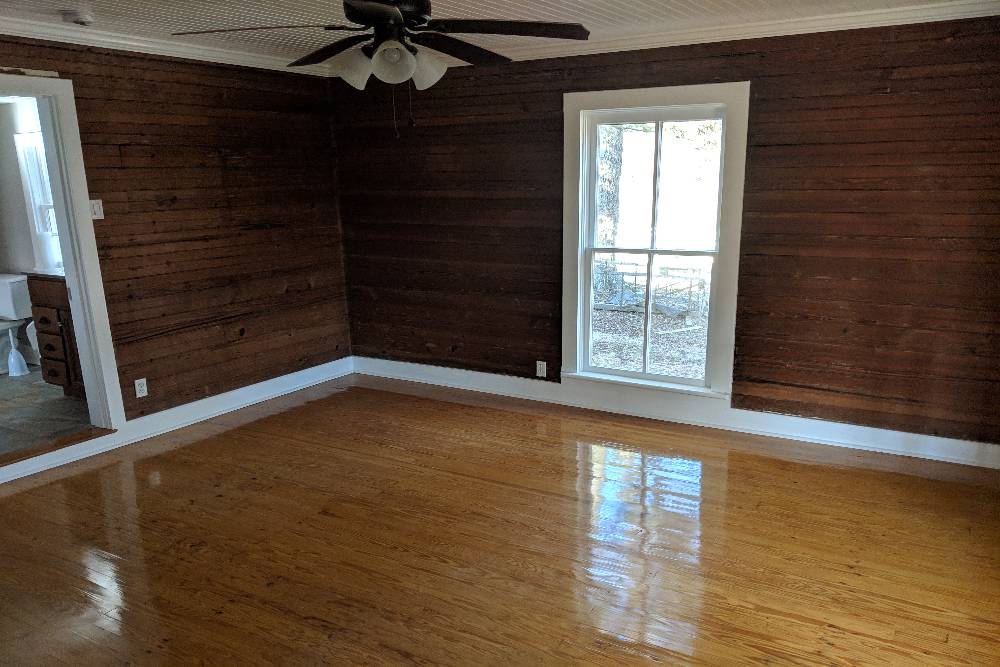Rustic interior with wooden walls and shiny hardwood floor