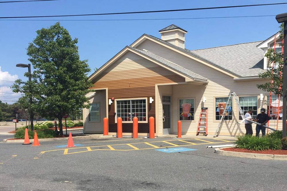 Commercial building exterior under renovation with a fresh new facade.