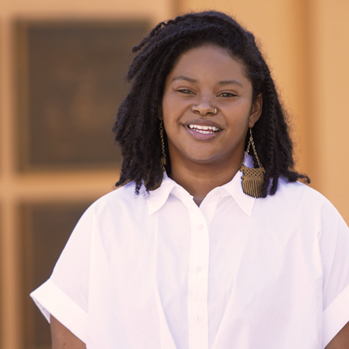 Disney Accounting and Finance Rotation Program participant Aundrea smiling. She has shoulder length black hair and is wearing a white collared shirt.