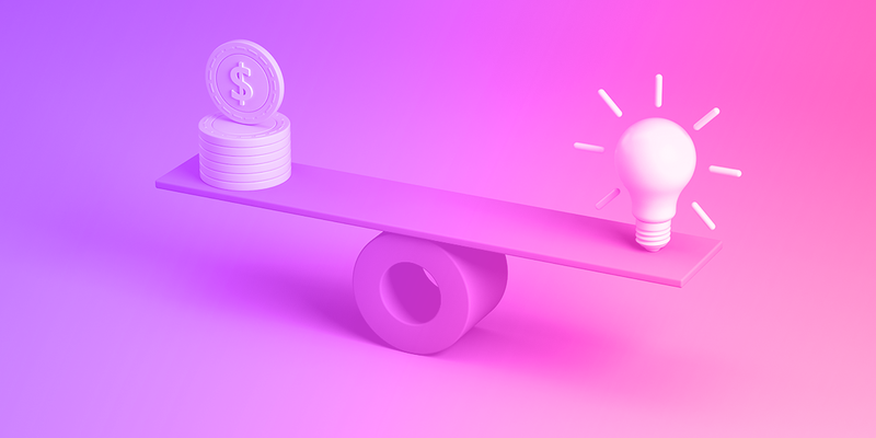 A board balancing on a cylinder with coins on one end of the board and a lightbulb on the other end