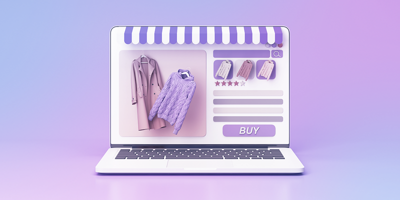 Laptop with awning on top of screen and a online retail store pulled up on screen displaying photos of sweaters and a button that says 'buy'