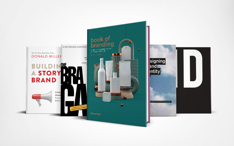 5 books lined up in a row, including Building a Story Brand and Book of Branding