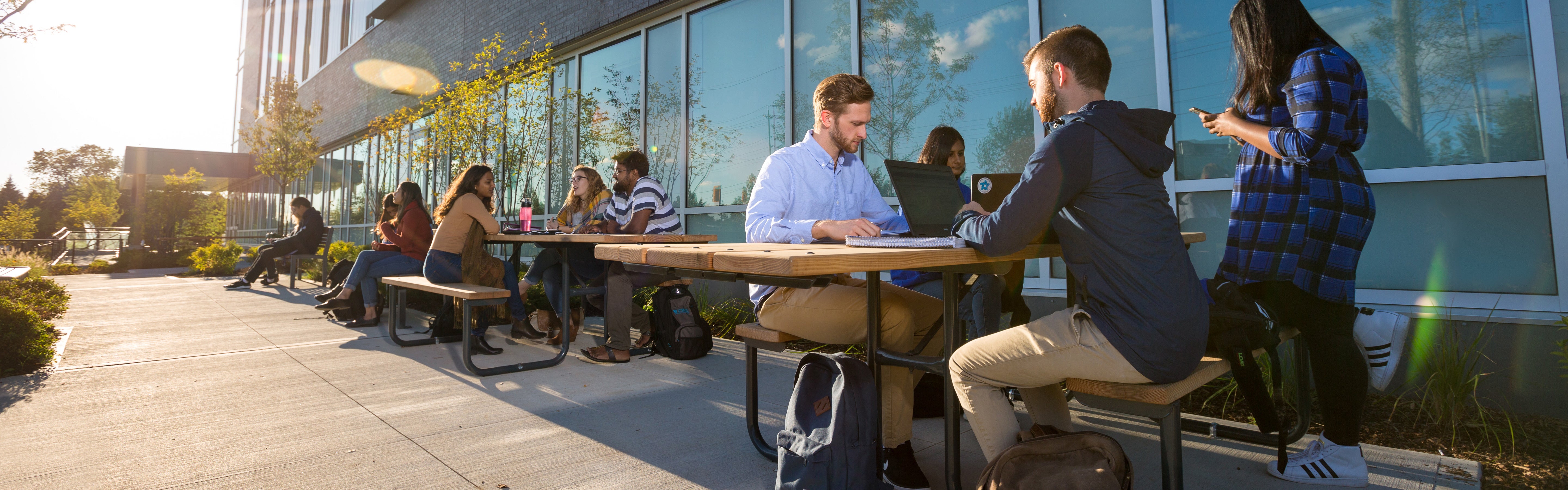 Students sitting outside at a table 
