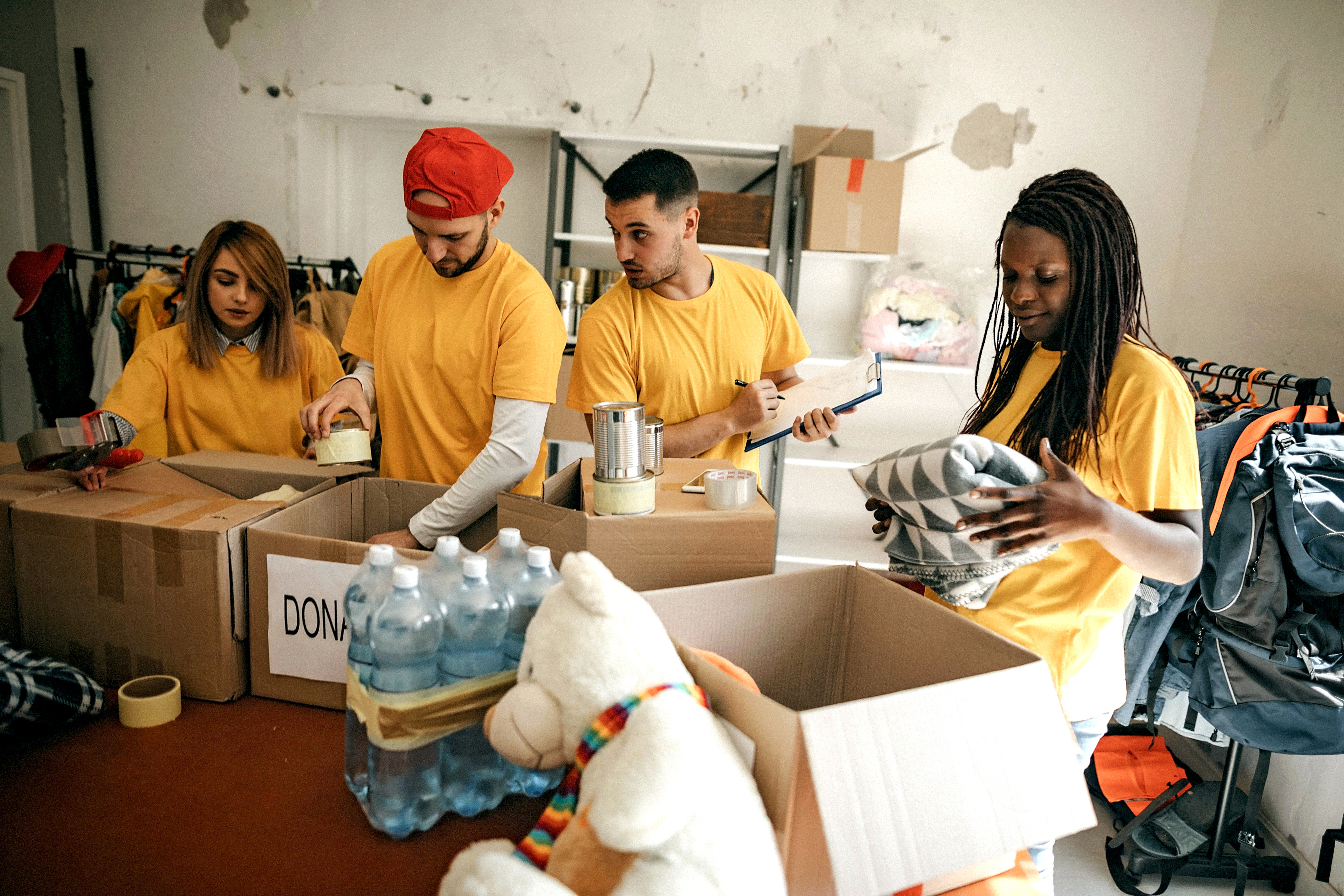 "group of volunteers unpacking food and supply donations"