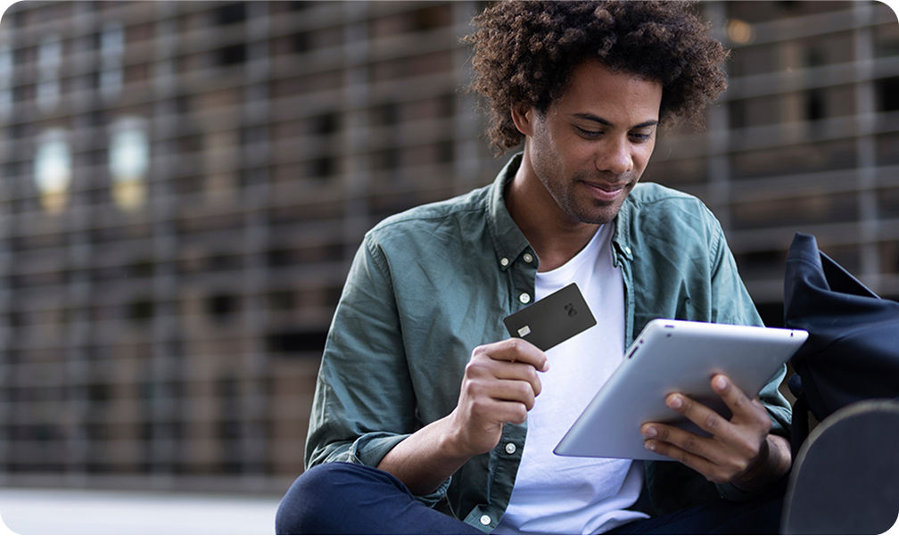 Man with card and tablet