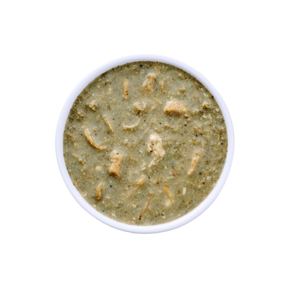 Top view of a white bowl filled with Wild Alaska pollock and chicken stew cat food, showing a moist, chunky texture with visible pieces of chicken and fish in a light gravy on a white background.