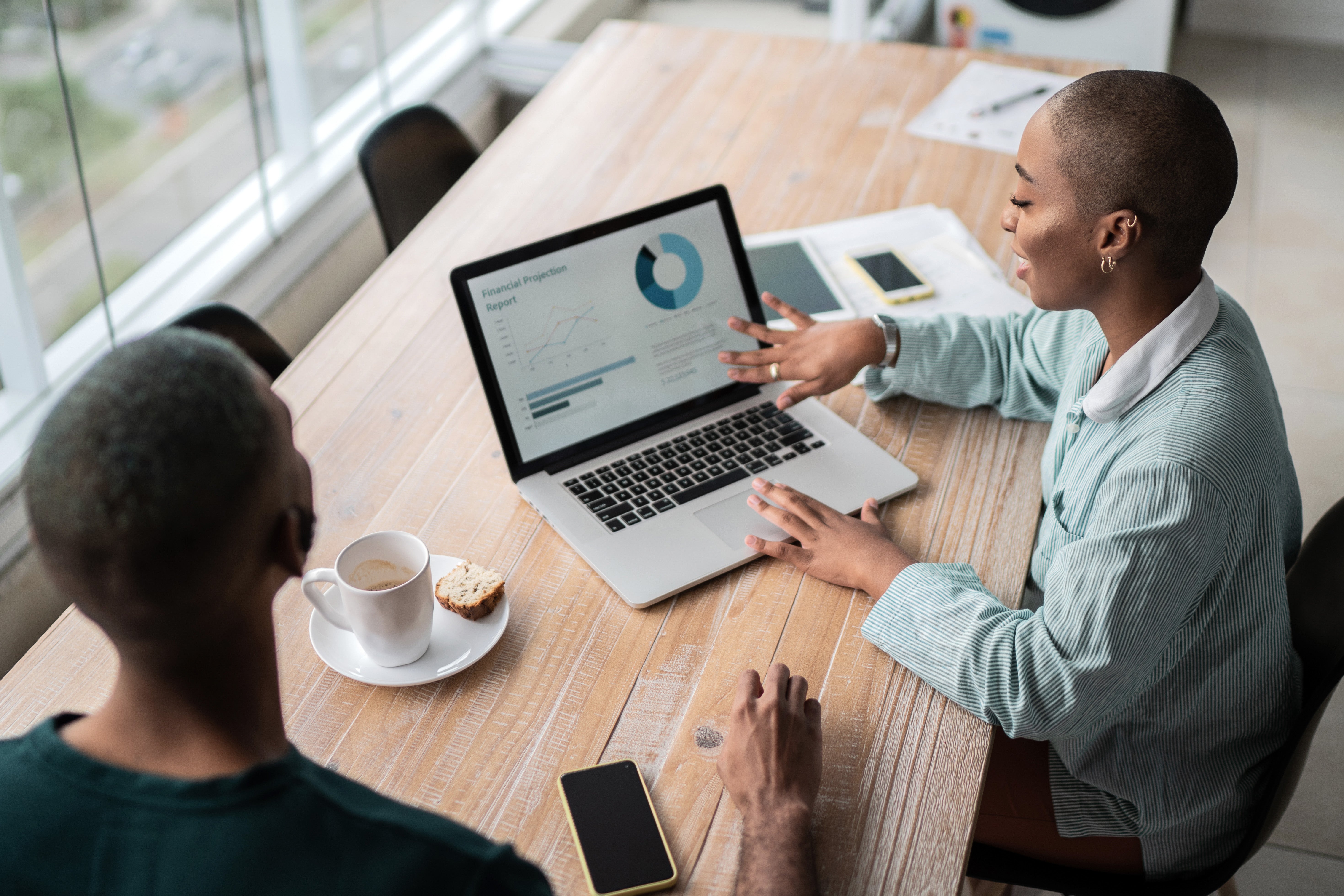 people reviewing data charts on a laptop