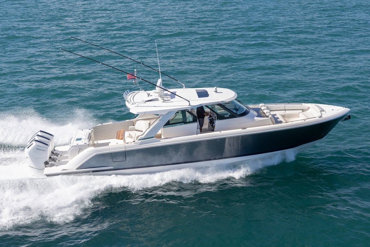 48 LS aerial photography, boat running to starboard. Hull Color &amp; Bootline: Windward Grey &amp; Flag Blue