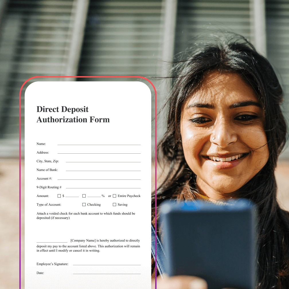 Woman smiling and looking down at phone.