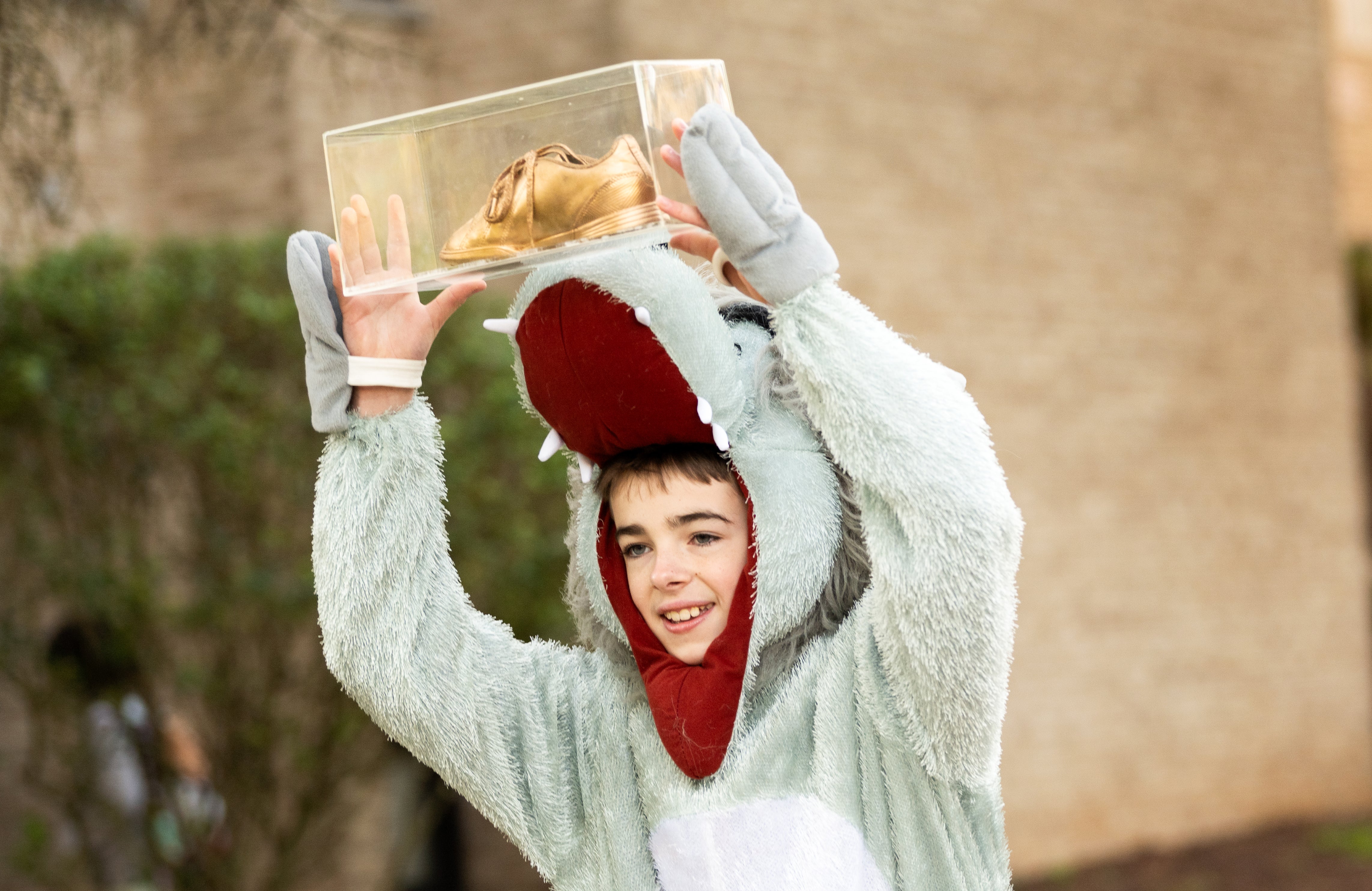 Drew Fields, dressed as Wolftrap's mascot, carries the coveted Golden Sneaker.