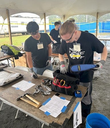 two students working together at an HVAC competition