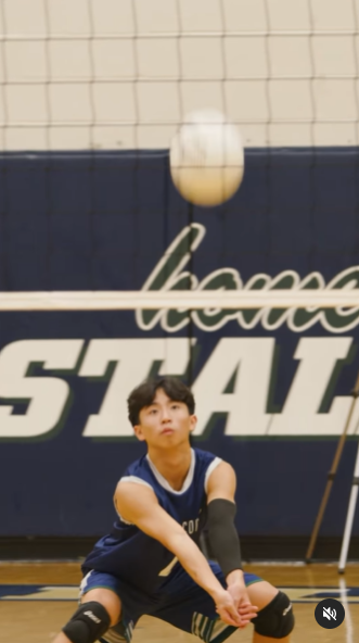 A young man plays volleyball