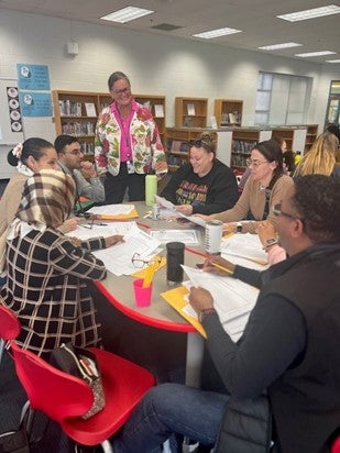 Dr. Reid watching a math professional development session at Columbia Elementary. 