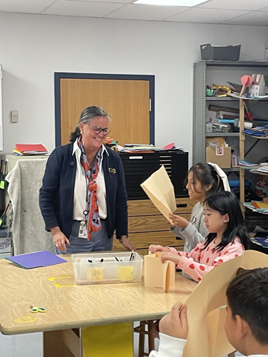 Dr. Reid talking with students in art class at Sleepy Hollow Elementary School. 