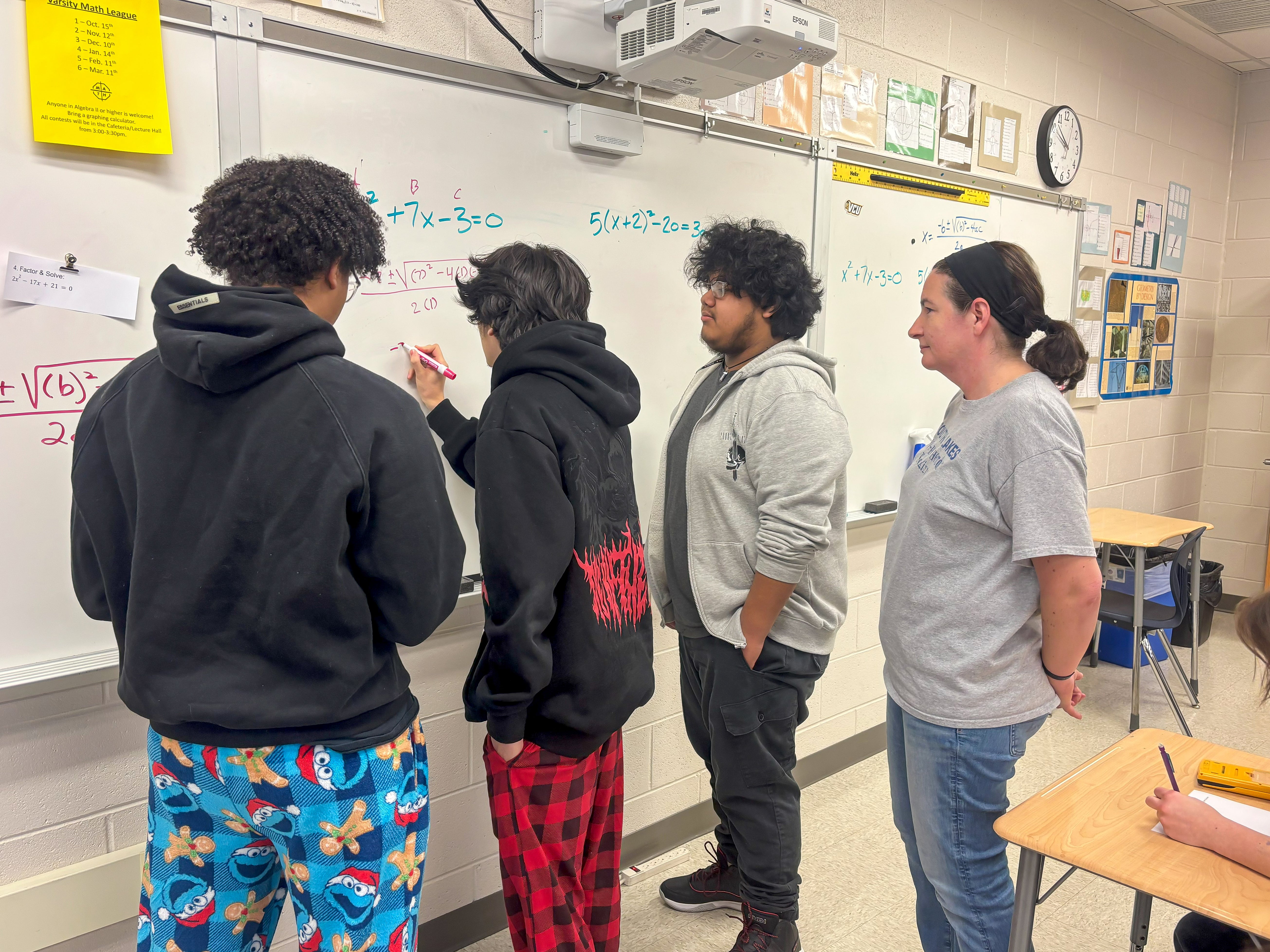 Emily and her students write on the whiteboard