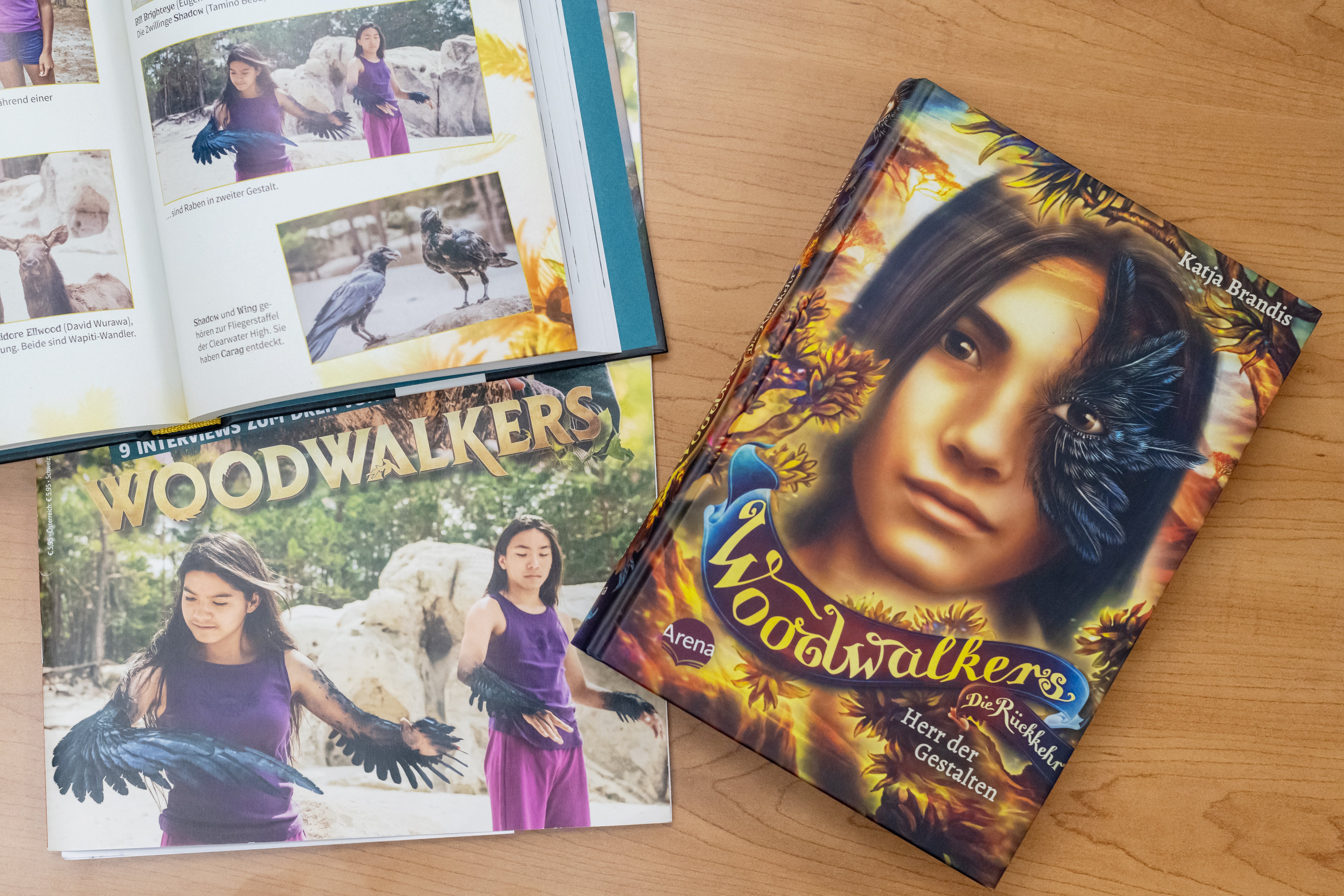 An image of Tamino Beba in Woodwalkers in a magazine. The Woodwalkers book next to it features his character, Shadow Feather.