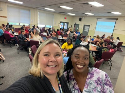 Teachers Claire Silva and Ruth Cheptoo taking a selfie at a meeting on Benchmark Advance.