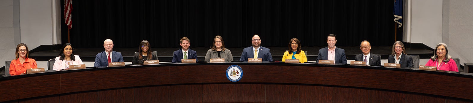 Fairfax County School Board members sitting behind the Dias