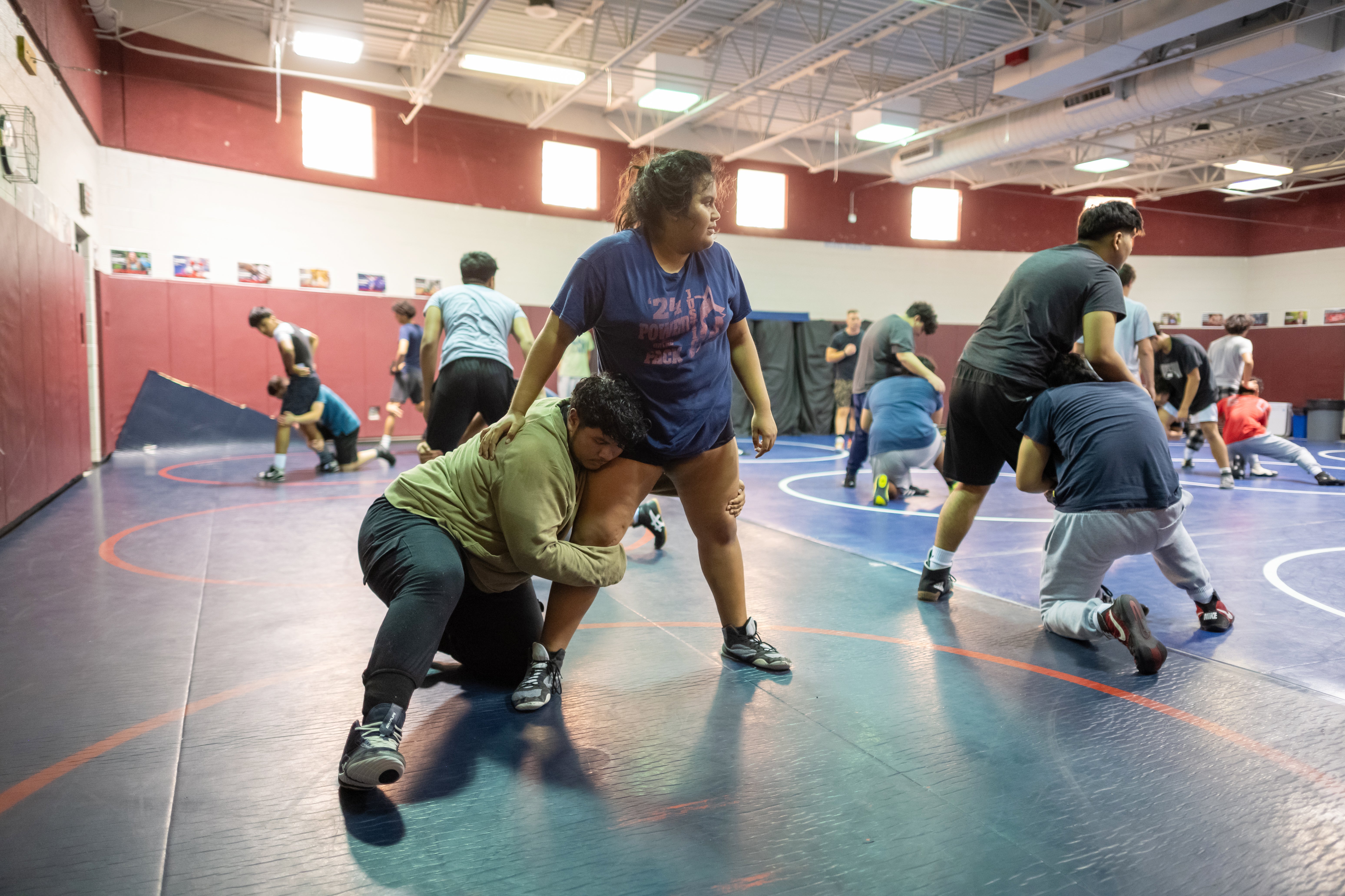 Sophia Cardoza Flores stands in the ring during wrestling tryouts at Justice High School.