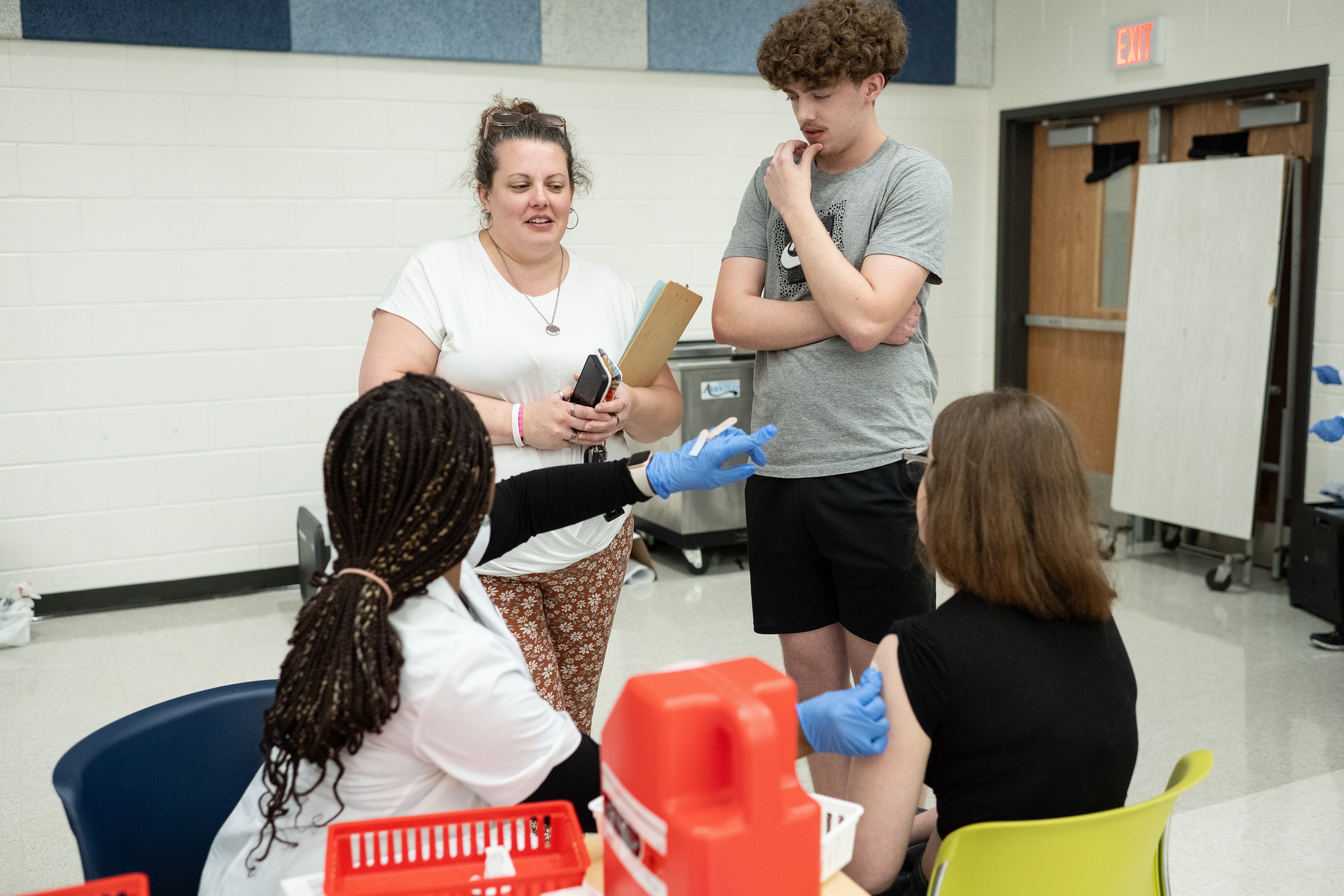 Westfield High School parent Tabitha Franklin accompanies her two children as they receive vaccines.