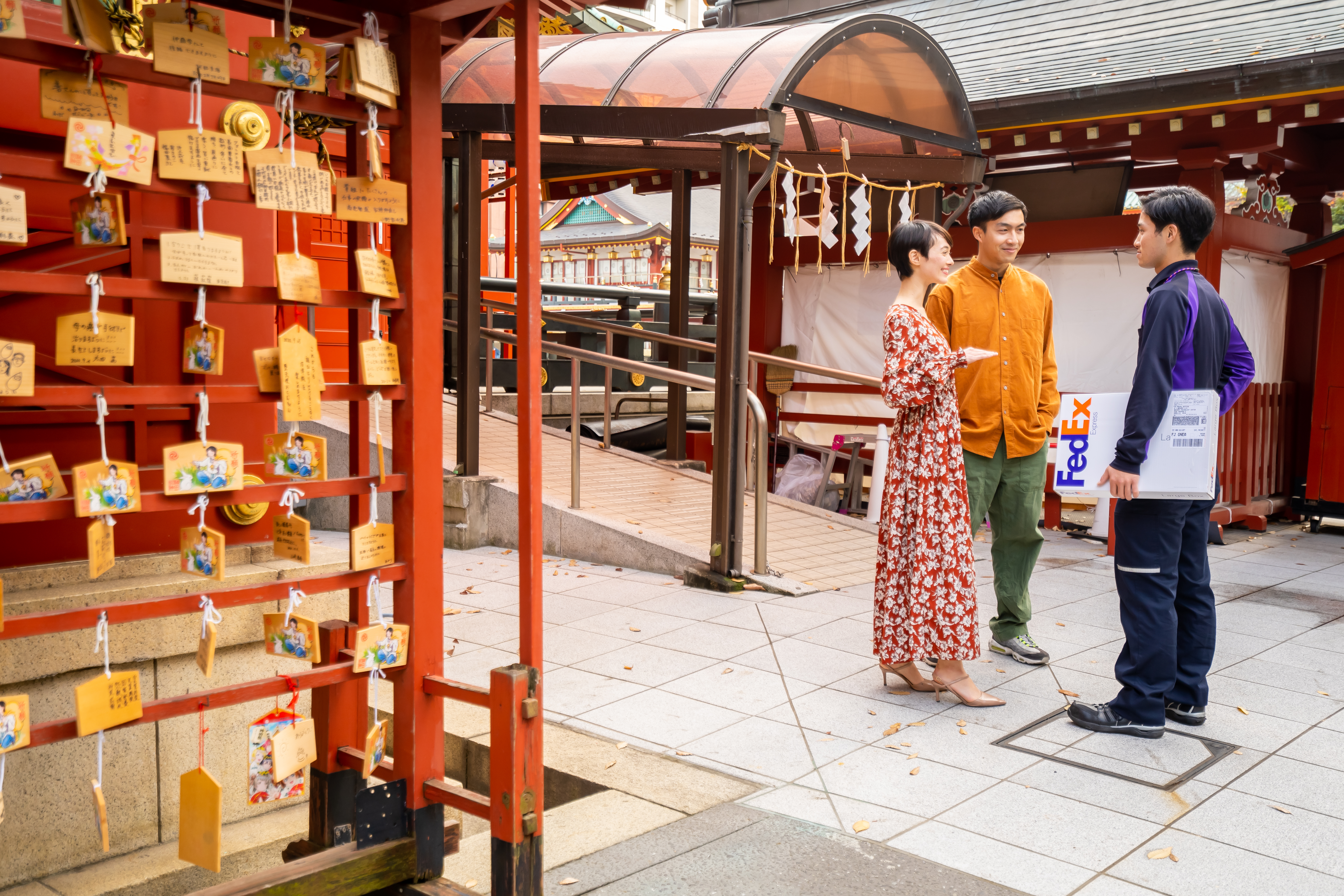 FedEx employee and customers standing in Asia market