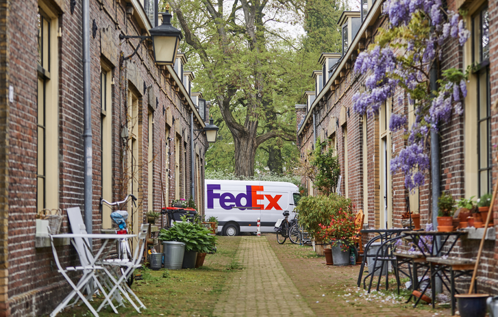 FedEx-bestelbus aan het eind van een rij huizen