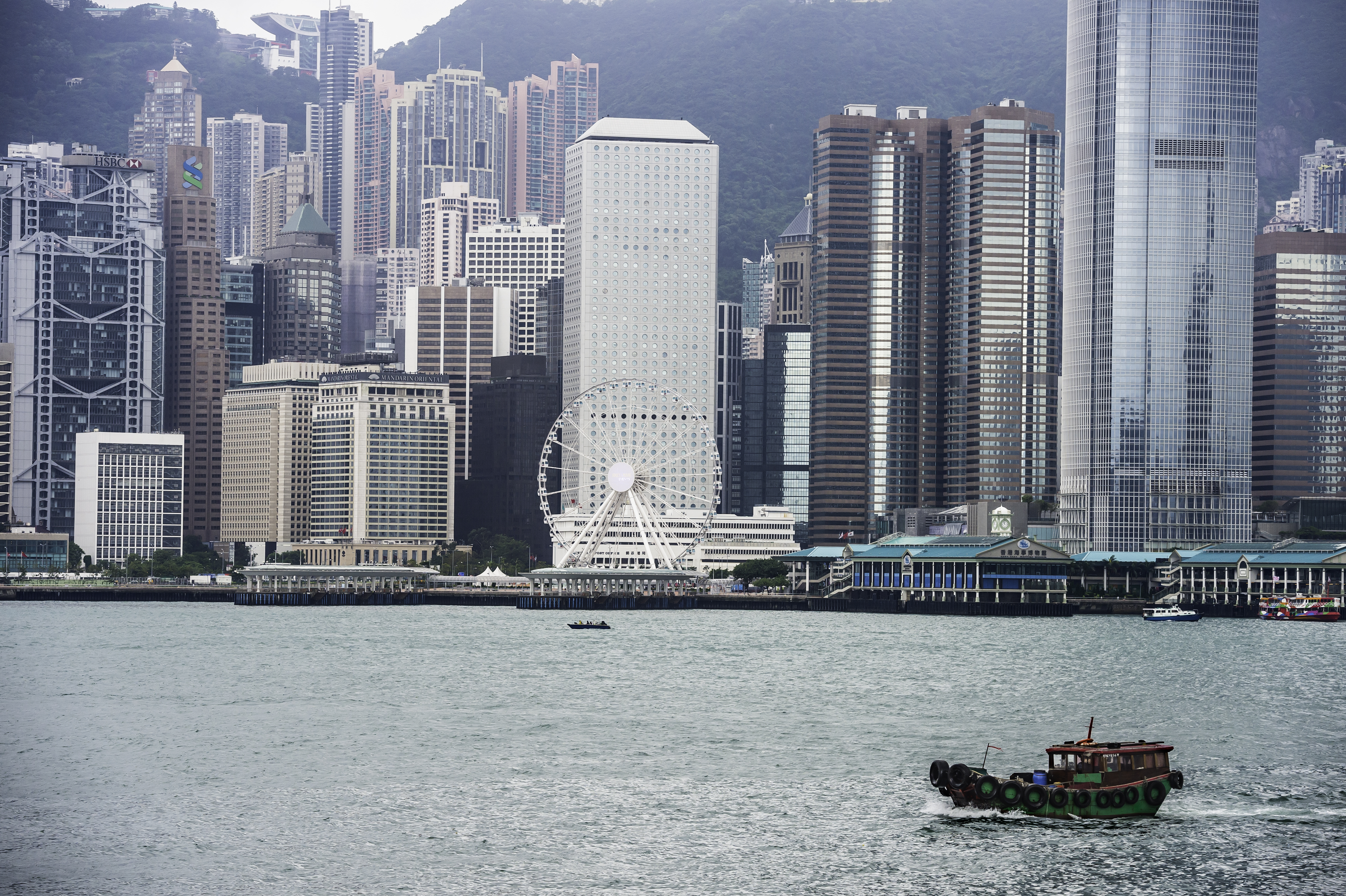 A tugboat heads toward a port along the coast of Hong Kong.