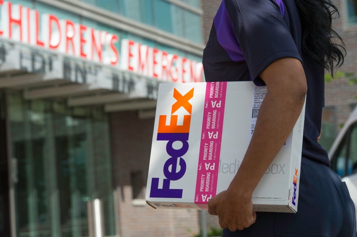 FedEx Express package under courier's arm