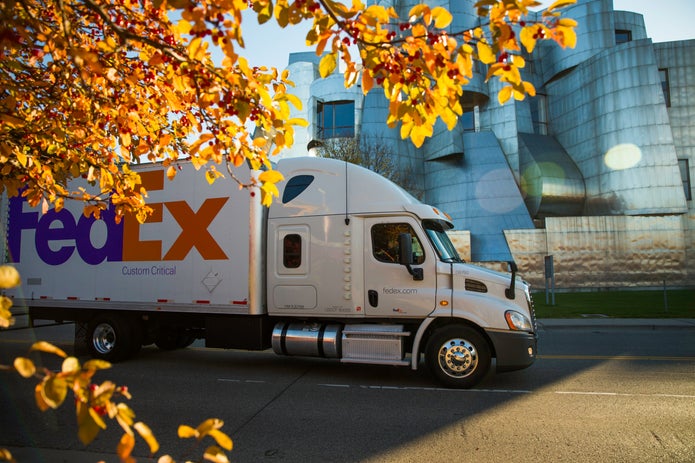 FedEx Custom Critical truck drives outside metal building