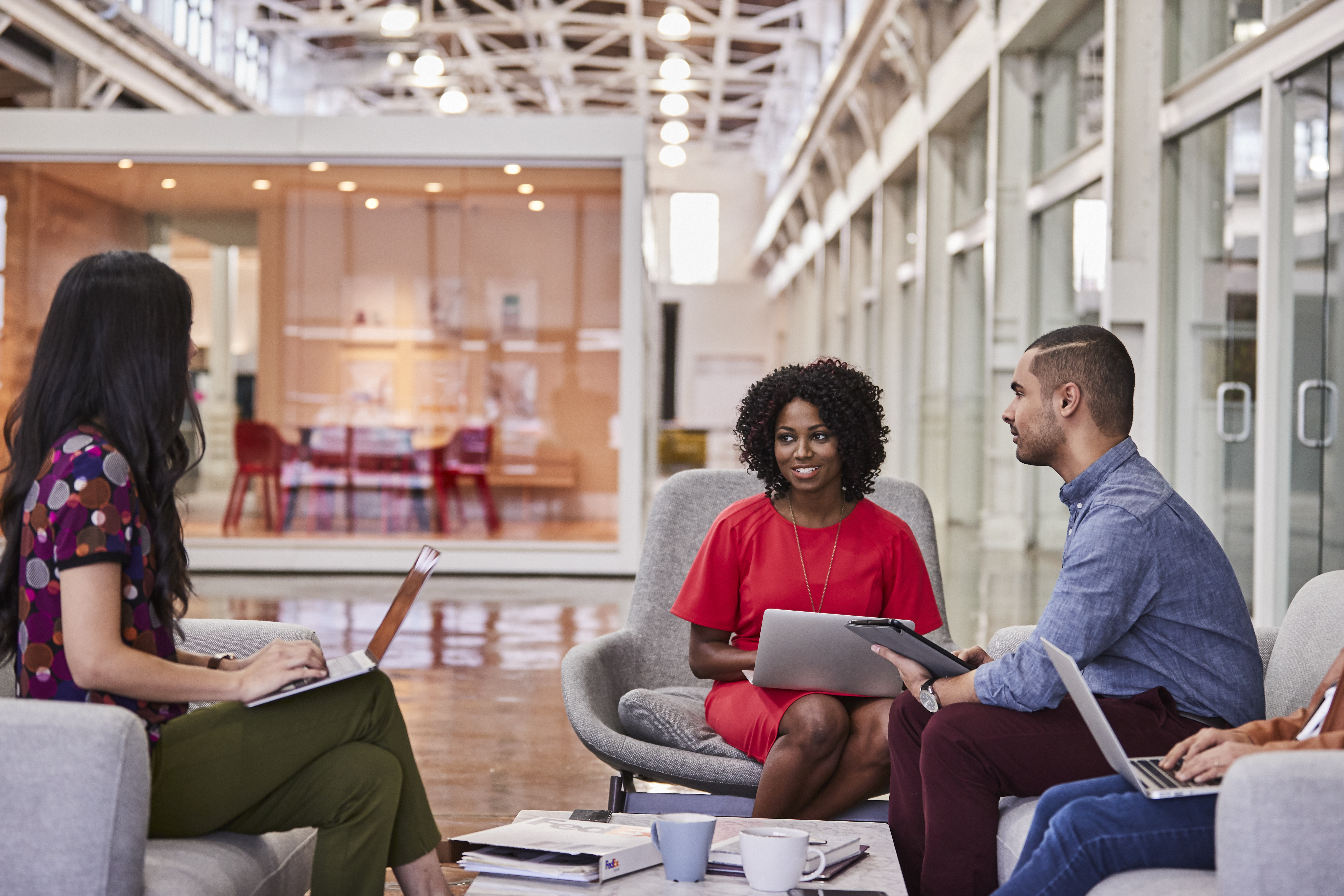Coworkers sitting together and smiling and talking