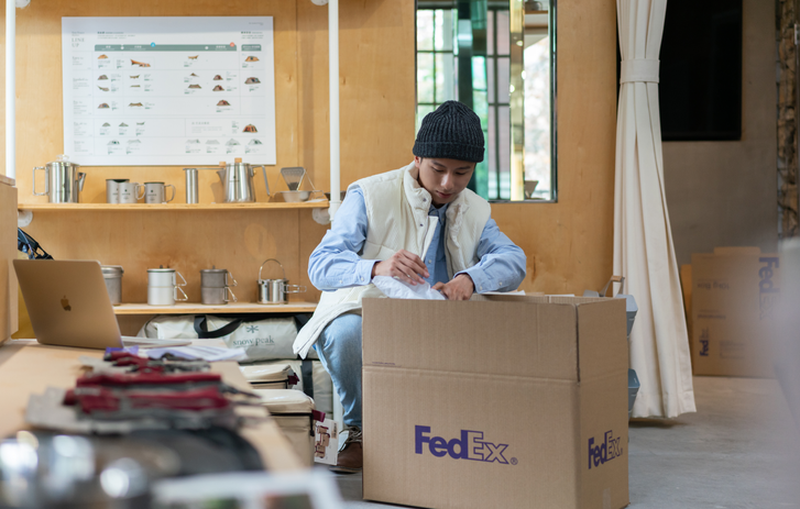 Hands putting a wrapped present in a box