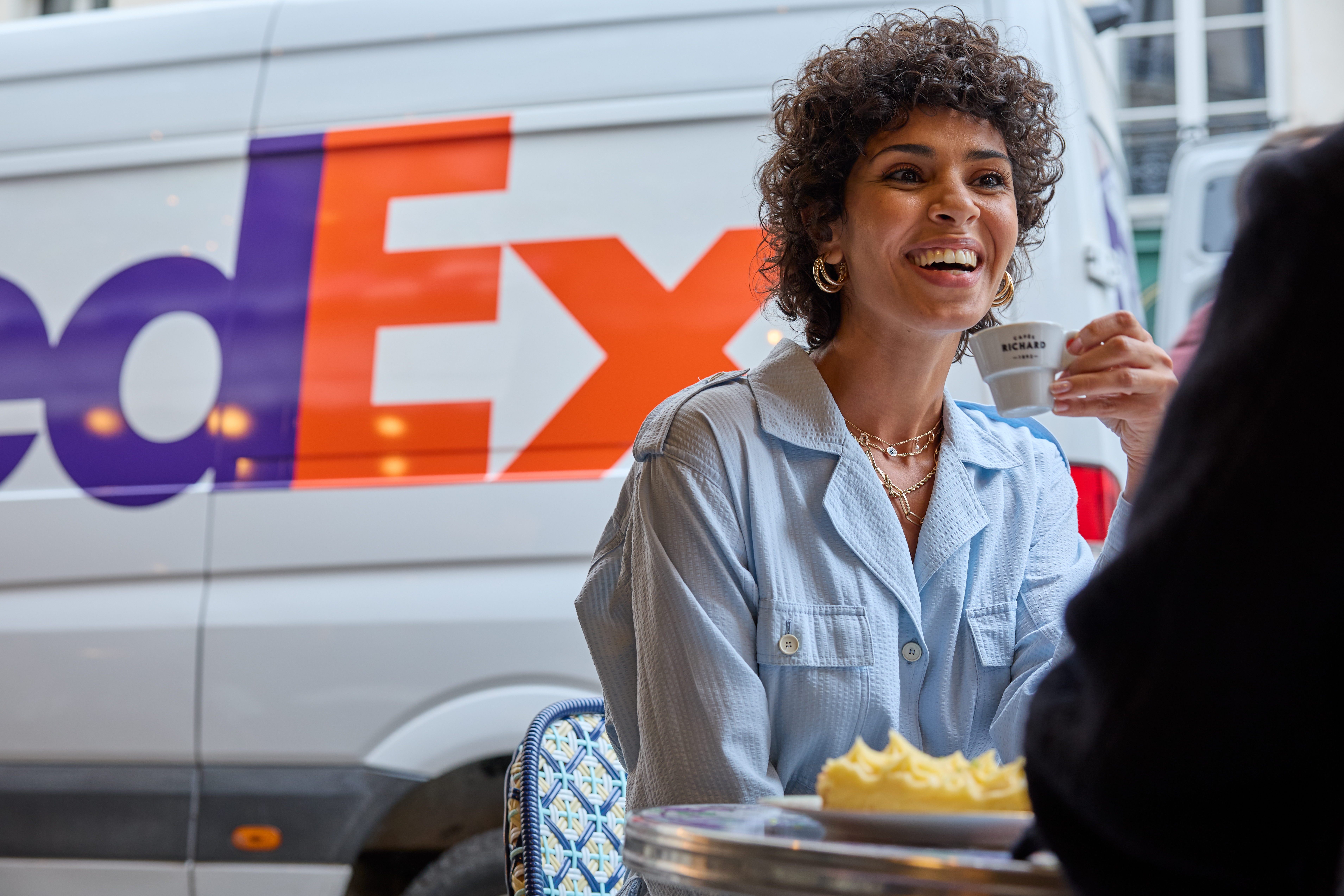FedEx van behind two people talking