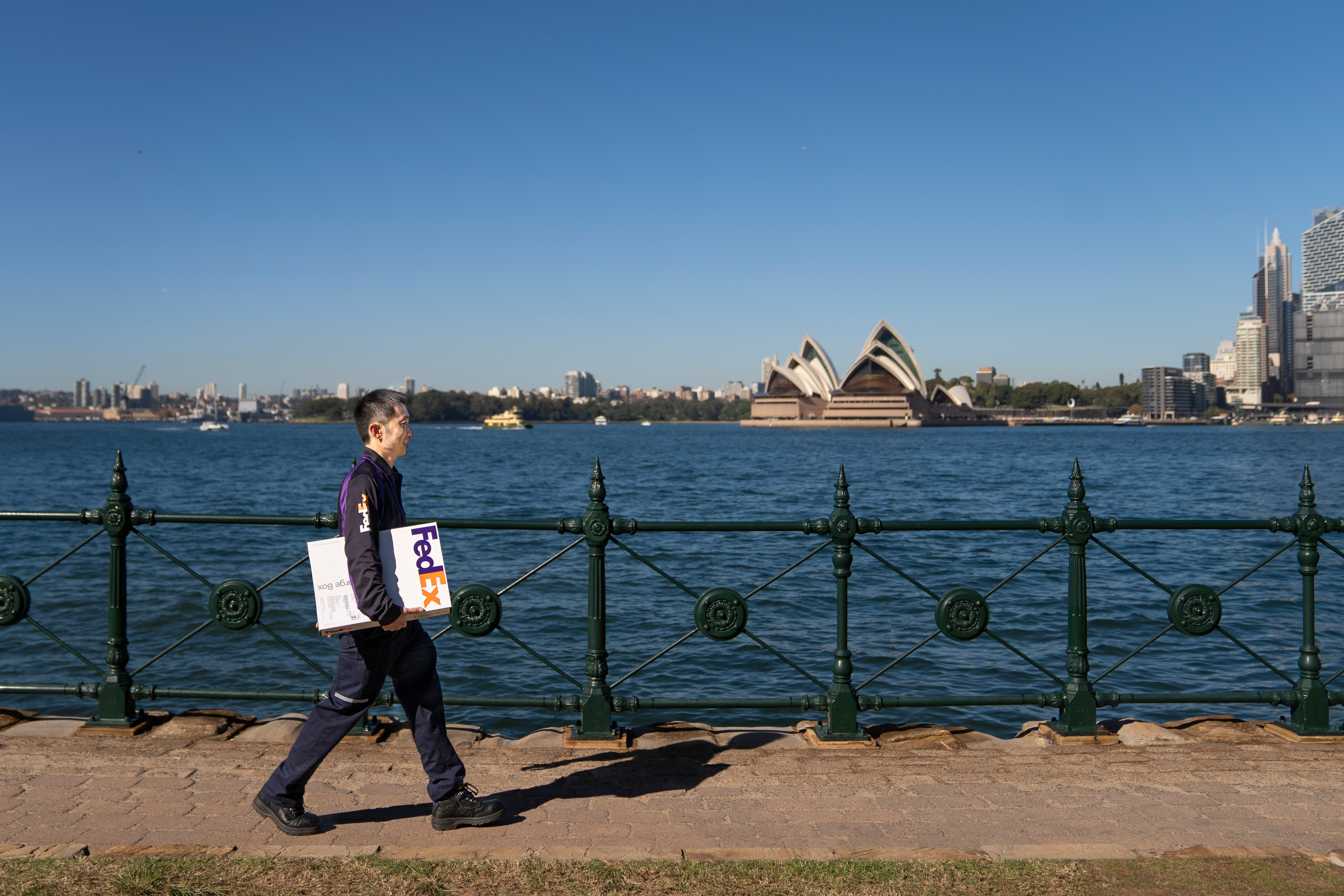 FedEx driver using a handtruck