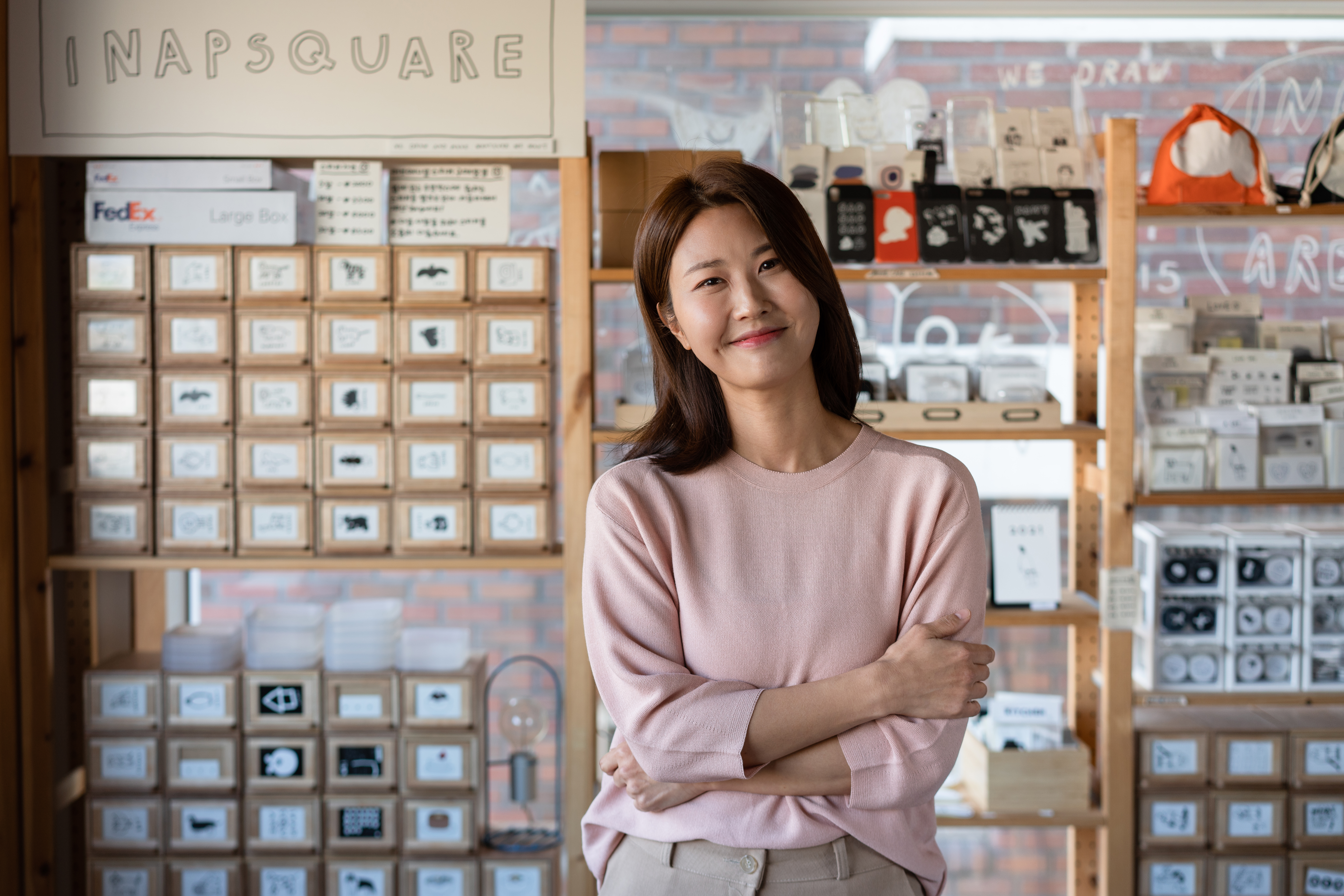 A woman smiling with her arms crossed