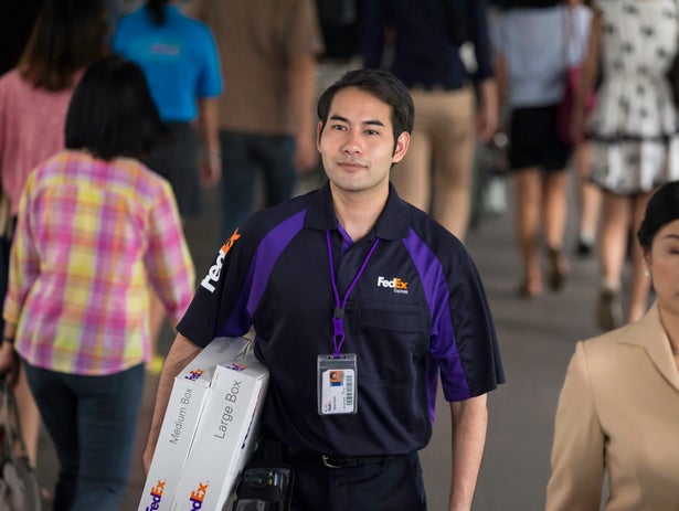 A FedEx Express employee delivers a package.