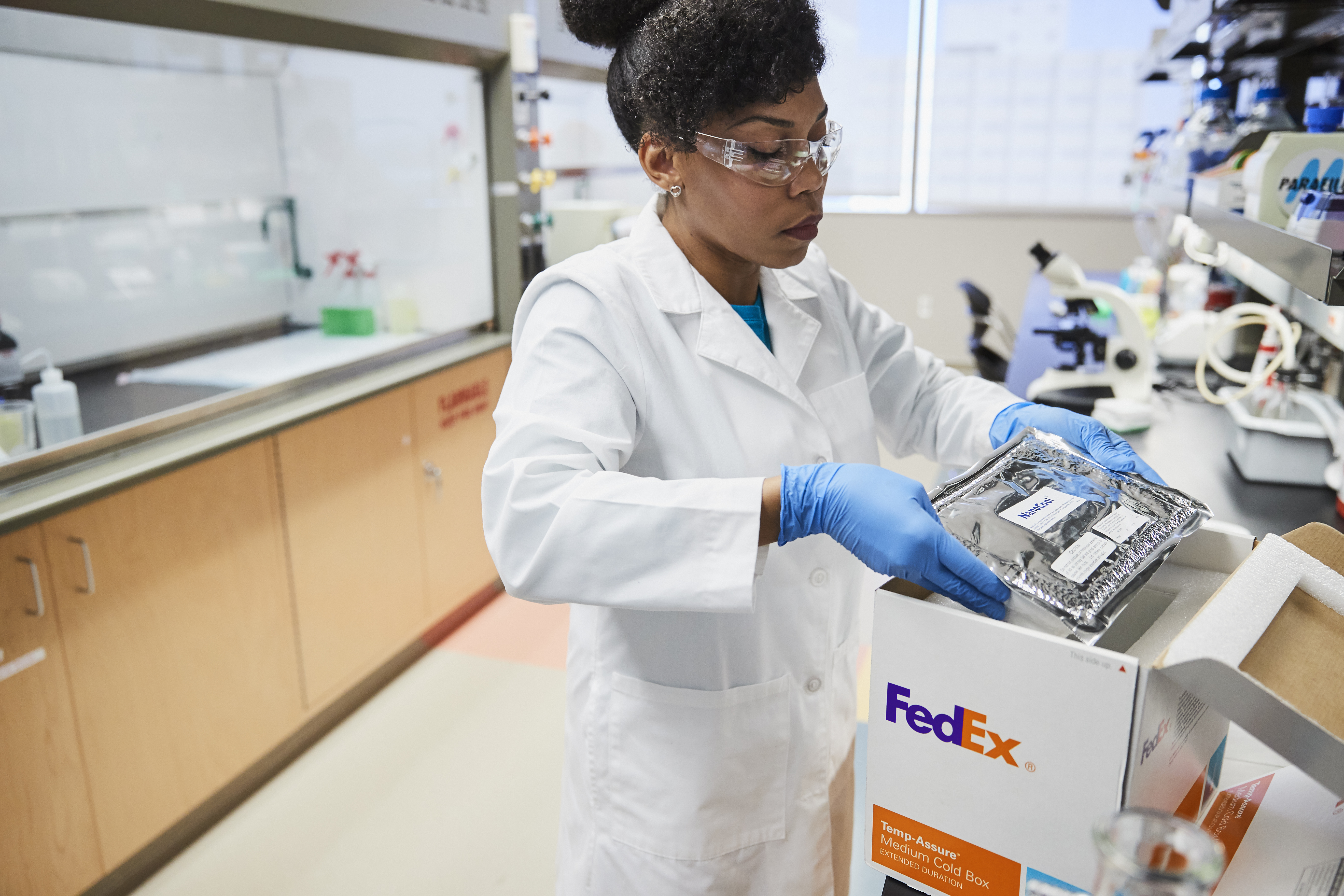 Woman placing item into temperature-controlled package