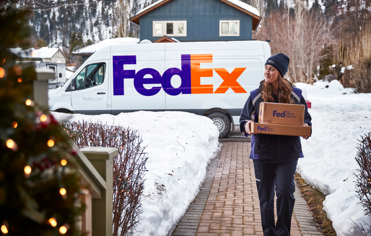 FedEx truck driving over bridge