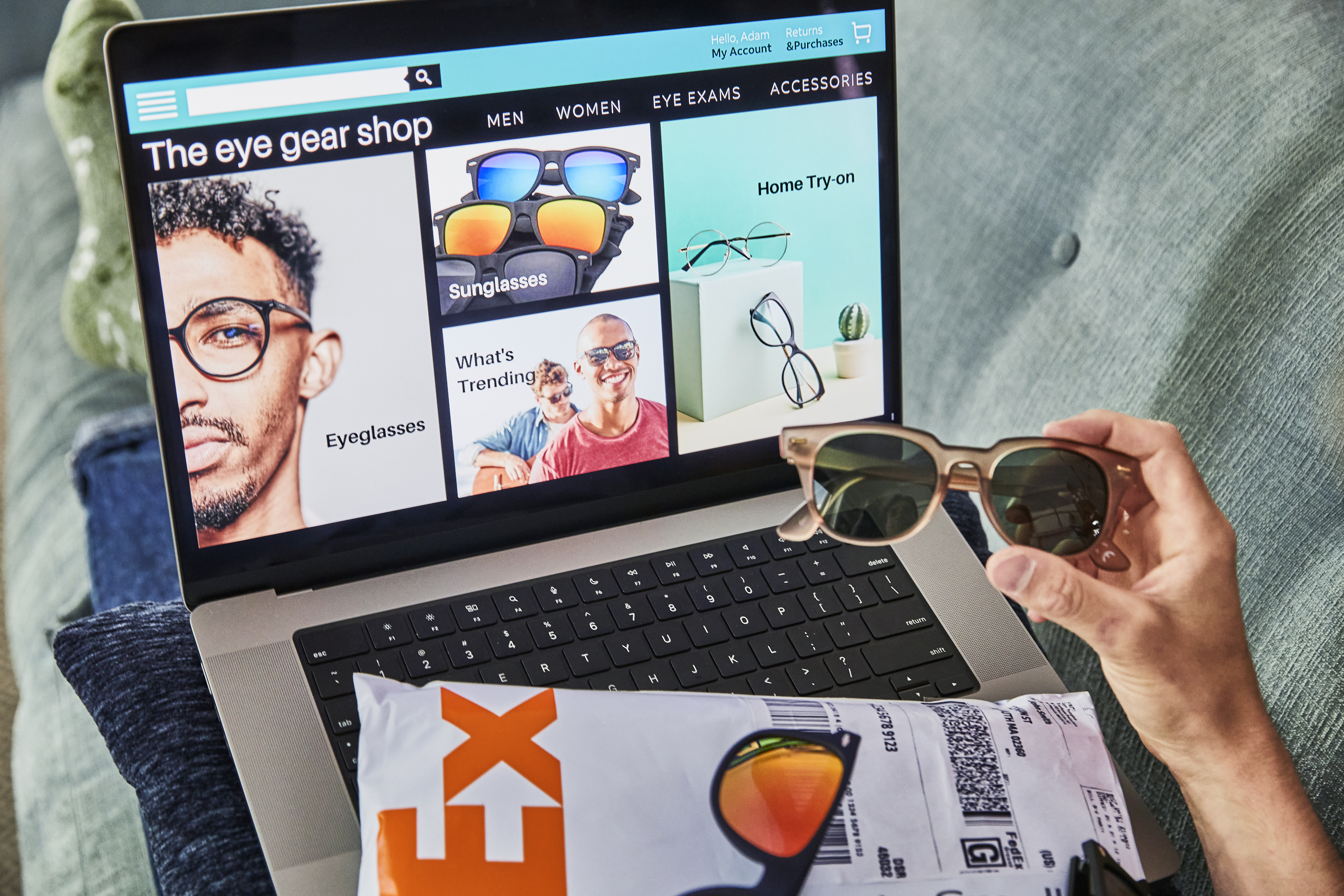 Man looking at laptop to purchase eye glasses