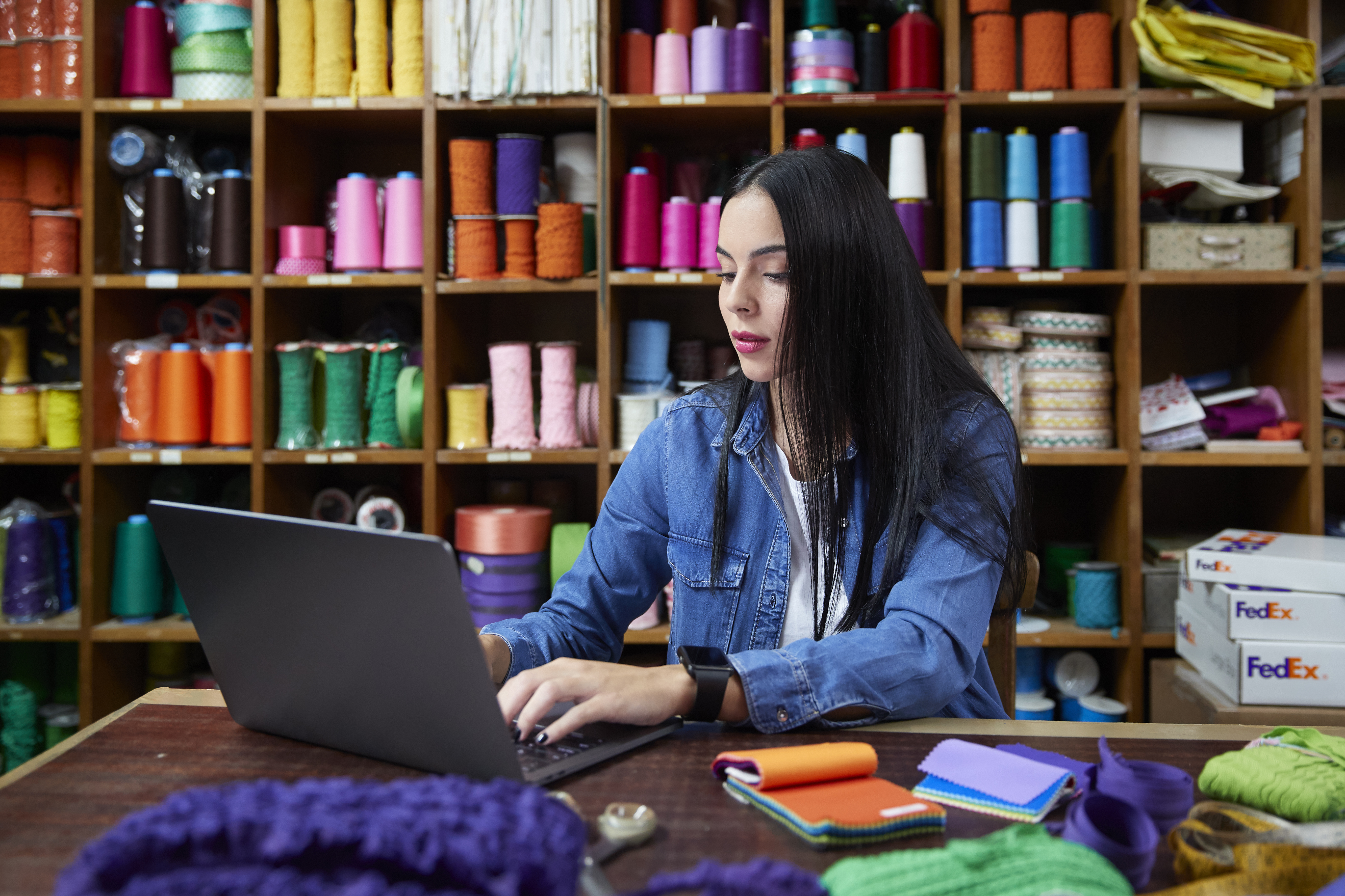Woman working on laptop in small business