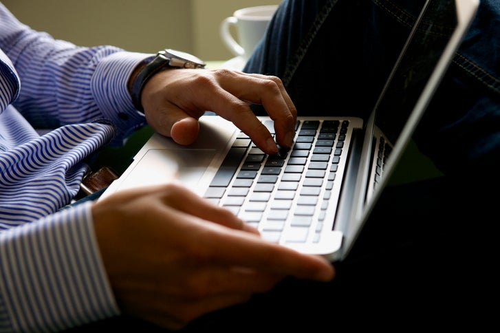 man typing on keyboard