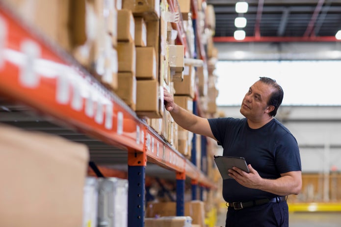FedEx Employee checking freight manifest