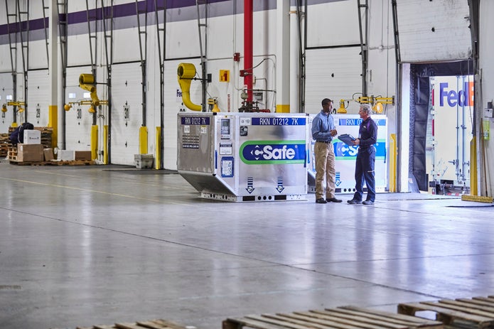 A FedEx employee consults with a customer