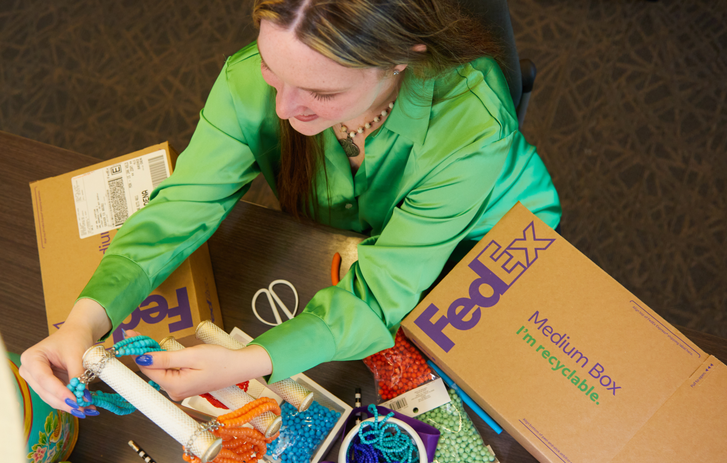 Hands putting a wrapped present in a box