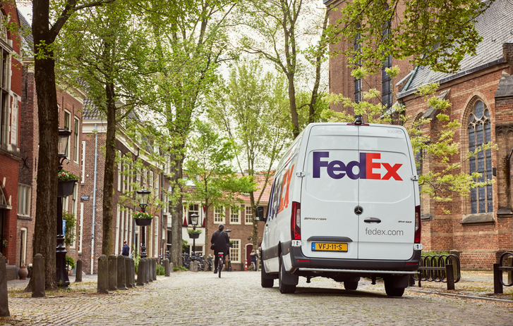 FedEx Express van driving down road