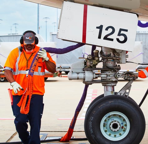 FedEx Employees working on a jet